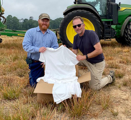 image of farmer Andrew Burleson and Eric Henry on farm with t-shirt made from their cotton.