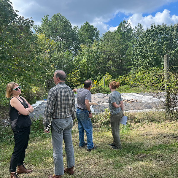 image of Courtney, Josh, Liana, and Eric planning over the dye garden.