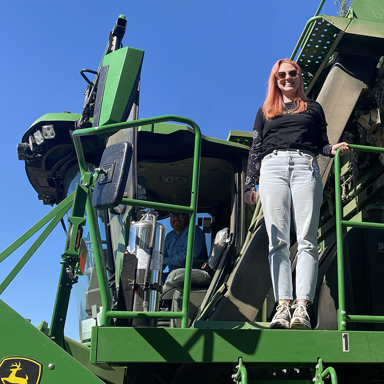Author Emily Stasiak on the harverster tractor when we visited the cotton farm.