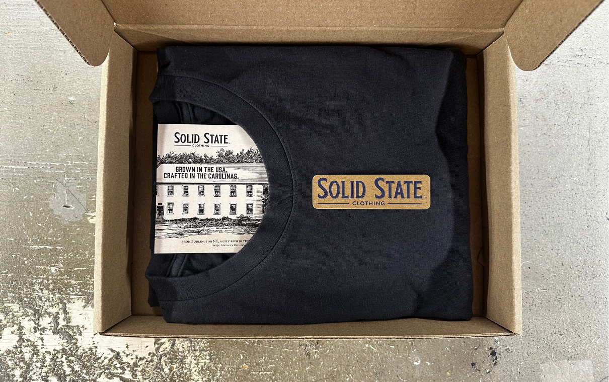 Image of Solid State Clothing delivered in a brown cardboard box, minimal waste and not plastic