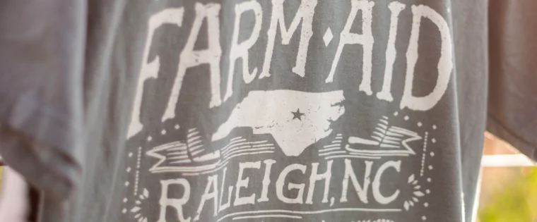 N.C. Organic Cotton T-Shirt Headlines Farm Aid’s Merchandise Table This Year